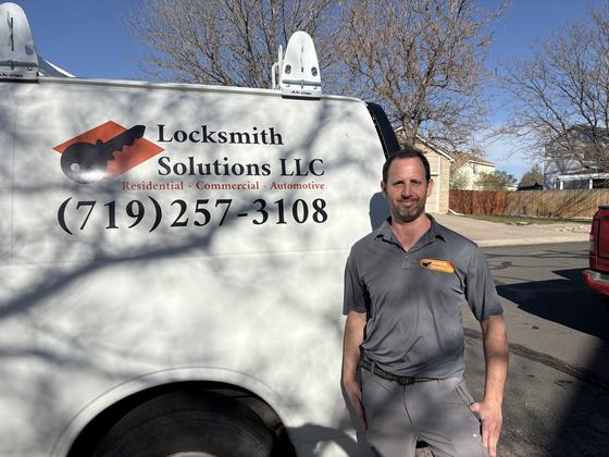Eyal from Locksmith Solutions LLC standing beside the mobile locksmith van